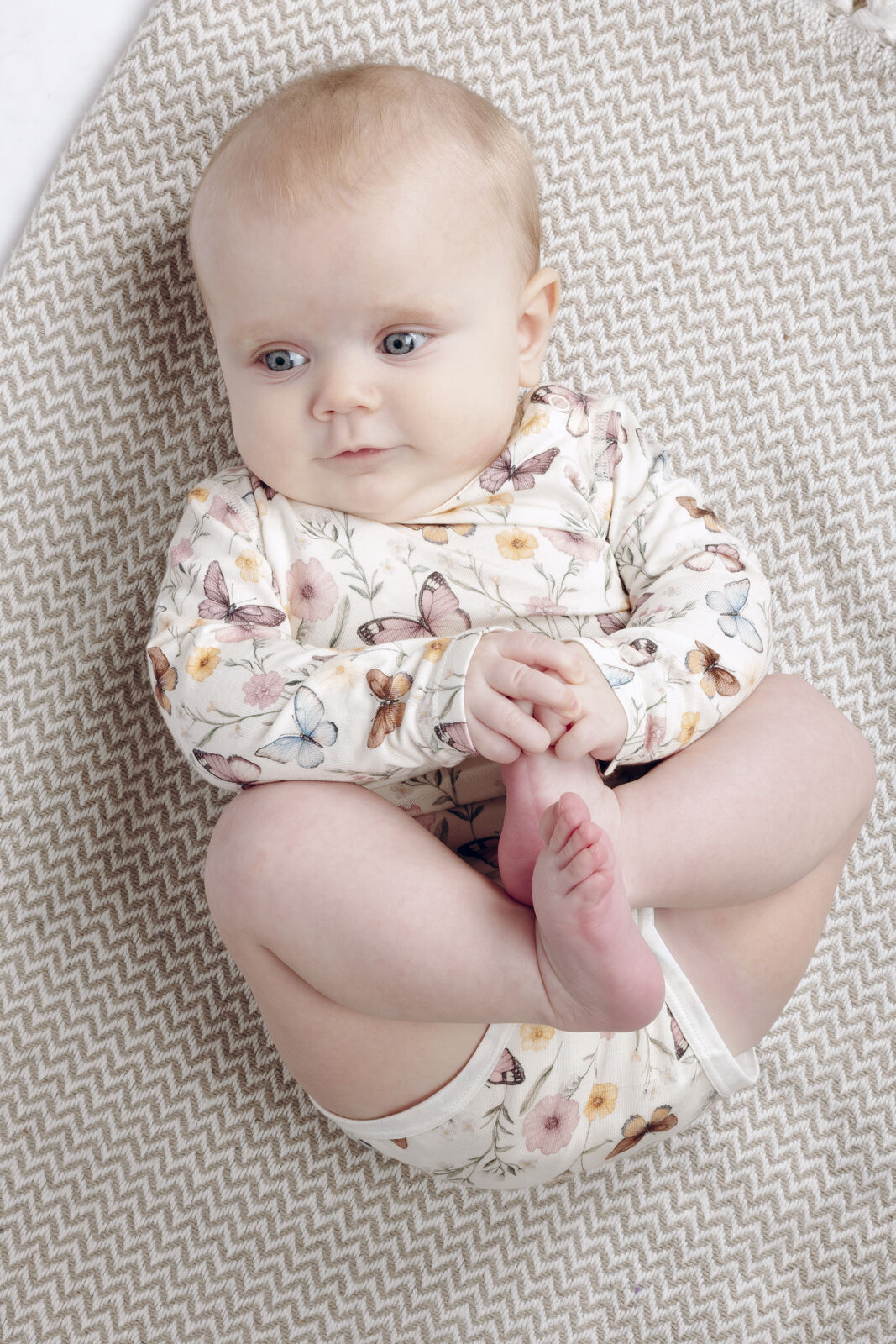 Baby trägt Hust&Claire Bambus Langarm Body mit Schmetterlingsprint im Bärechind Kinderladen Winterthur, Zürich, Schweiz.