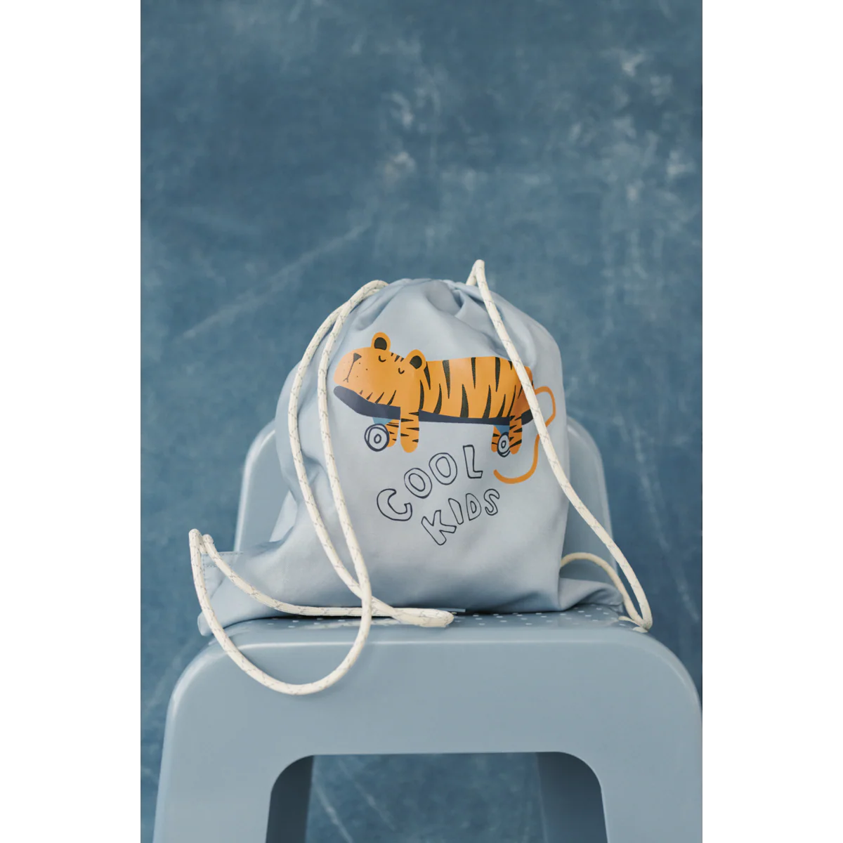 Kind trägt Liewood Danella Turnbeutel mit Tiger Motiv Beach Blue – nachhaltiges Kinderaccessoire bei Bärechind Winterthur, Zürich Schweiz.