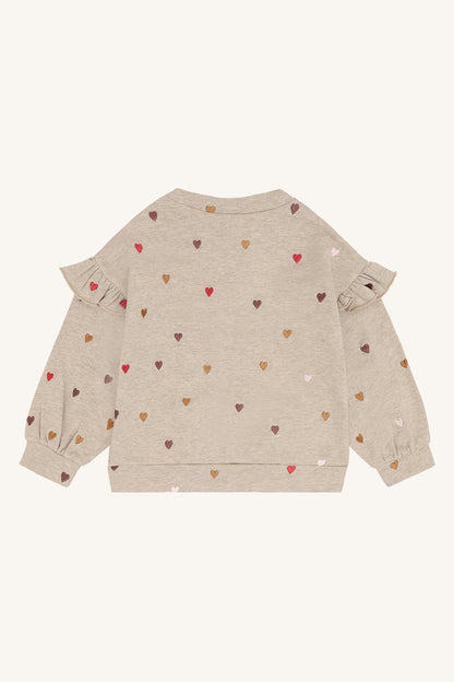 Rückansicht des weichen Baumwoll-Langarmshirts mit Rüschendetail an den Schultern