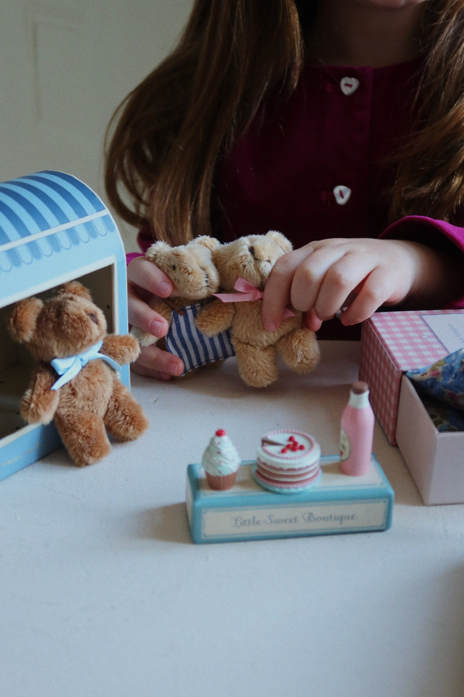 Kind spielt mit dem Konges Sløjd Mini-Teddy Elise