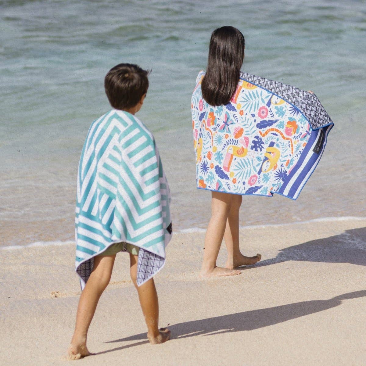Kinder am Strand mit leichtem und schnell trocknendem Woods & Waves Strandtuch Jungle Fever